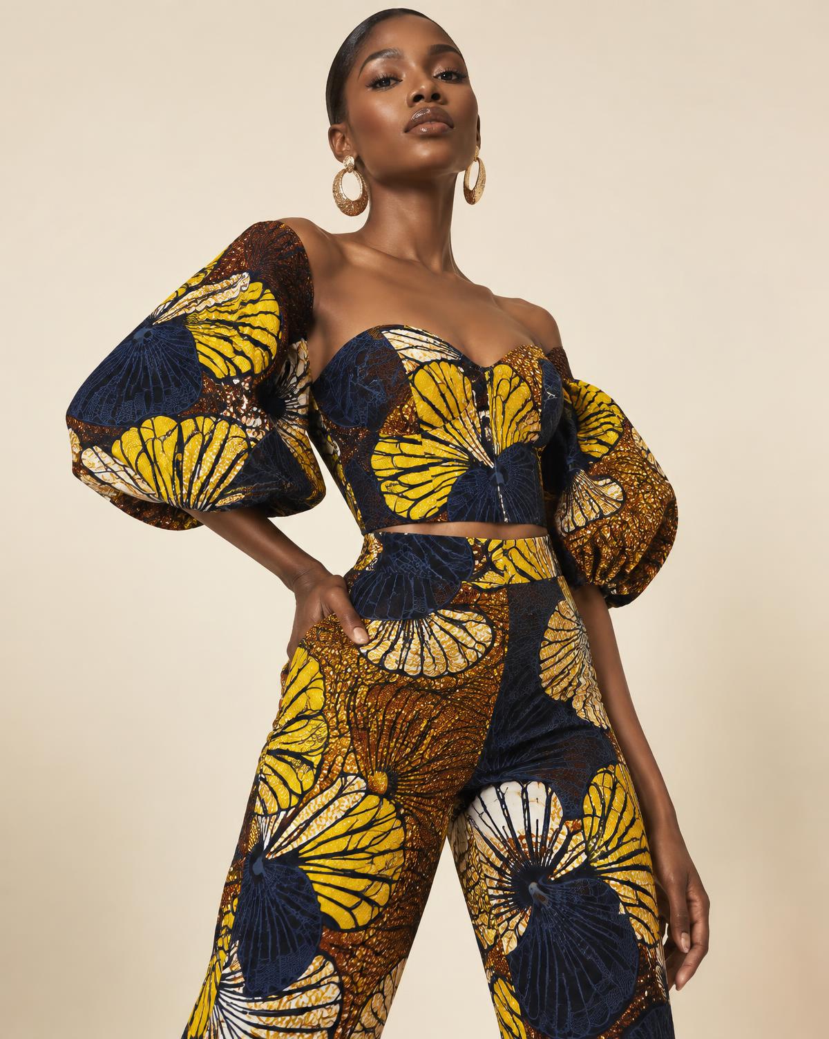 Woman in a modern Ankara print two-piece outfit with statement sleeves